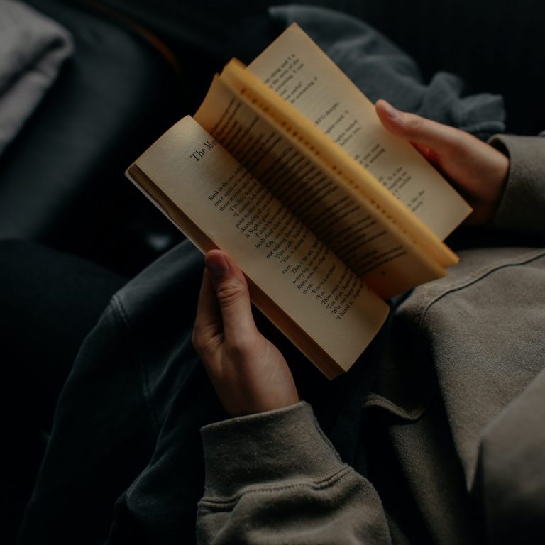 person reading book white sitting