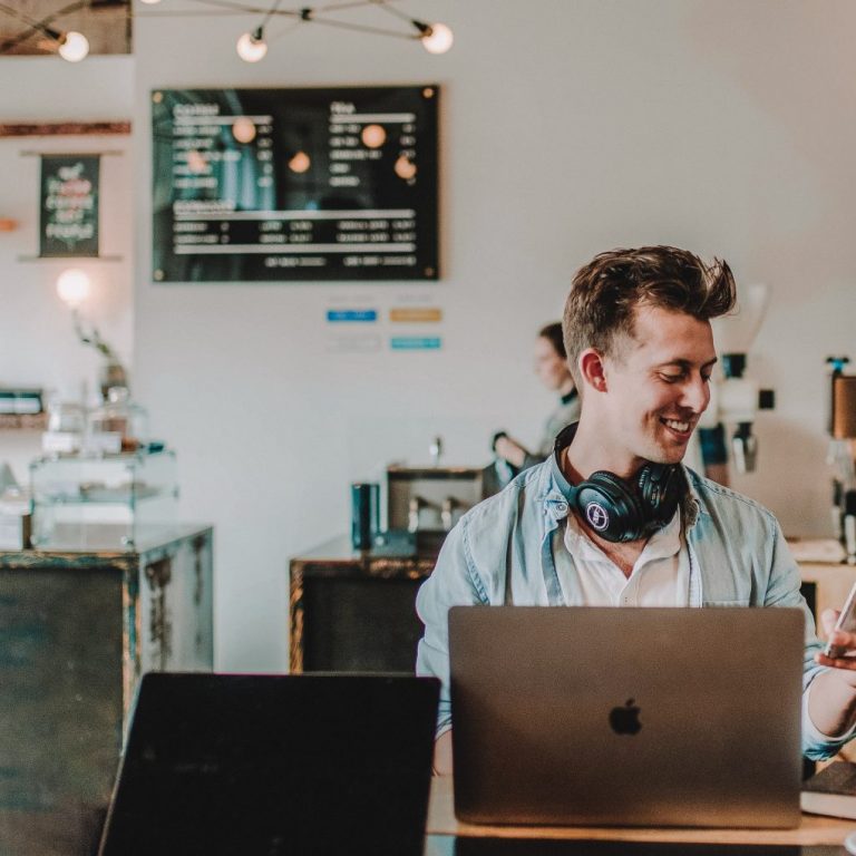 man using smartphone smiling