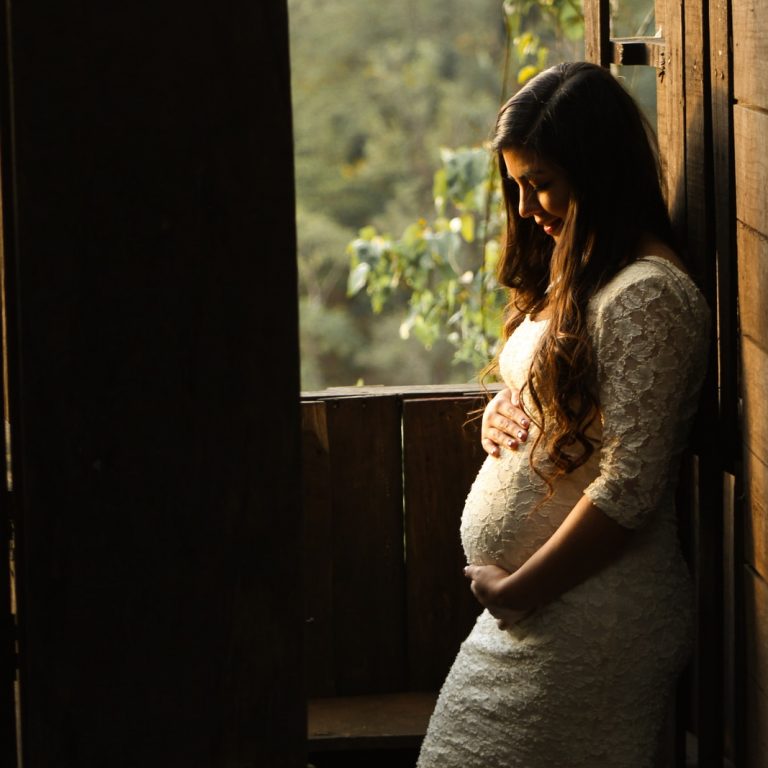 pregnant woman holding her womb